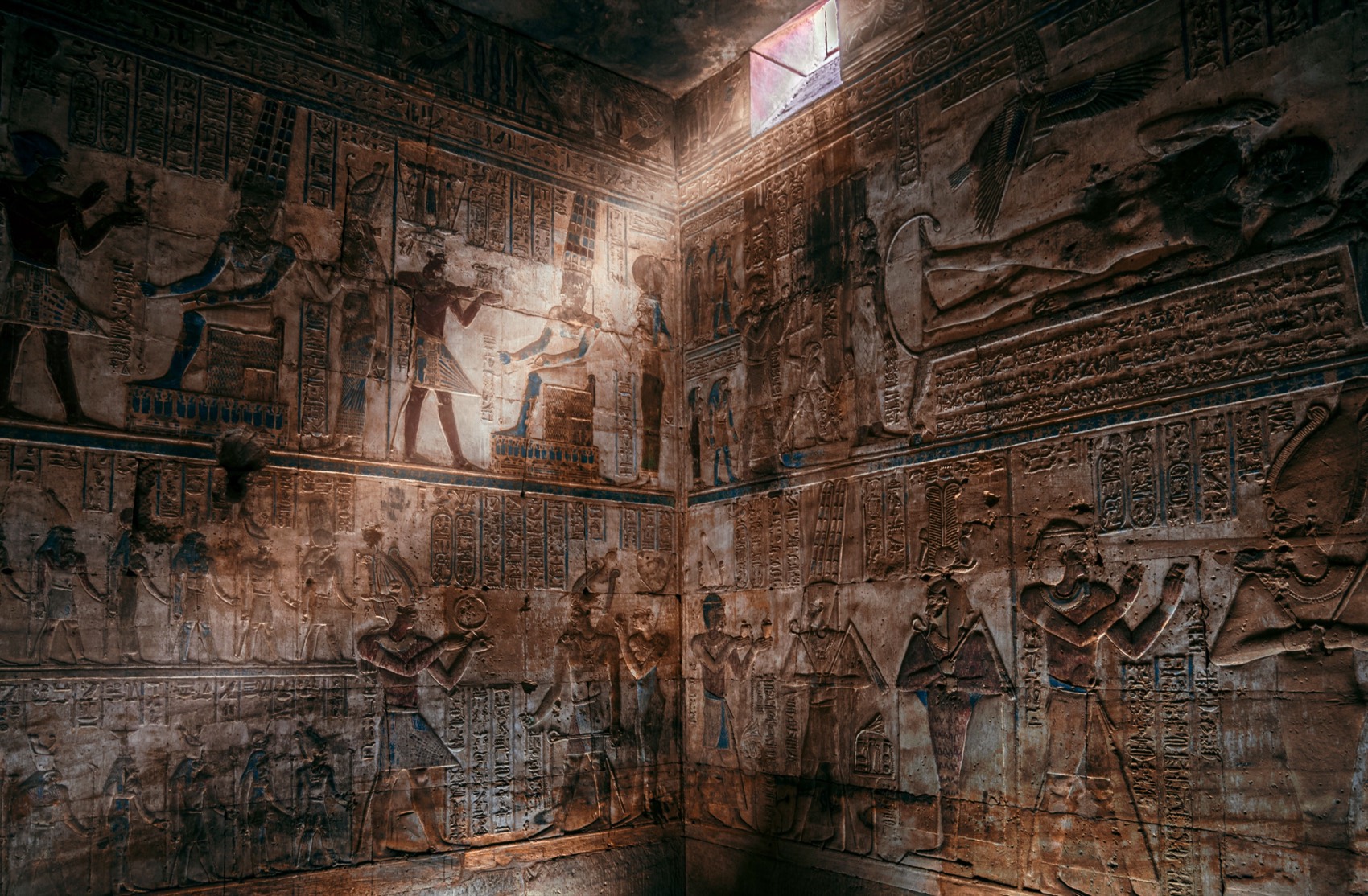 Sunlit Egyptian hieroglyphs on temple walls